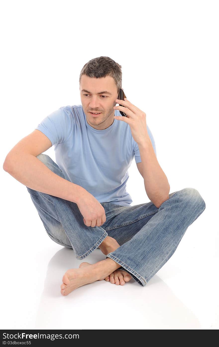 Casual young man speaking on phone