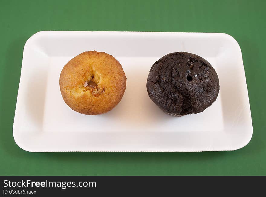 Chocolate and vanilla muffins on white tray