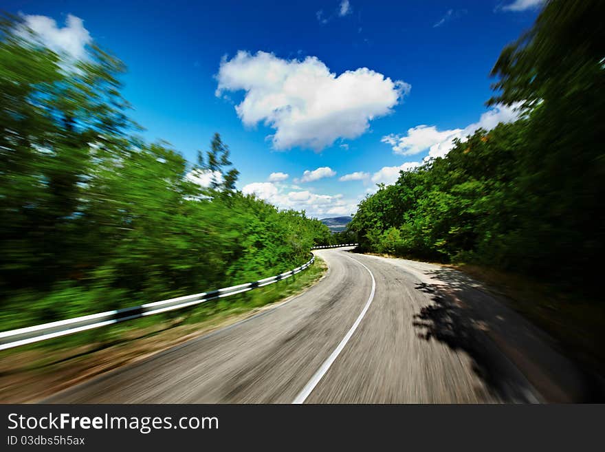 Blured road and blue sky with clouds