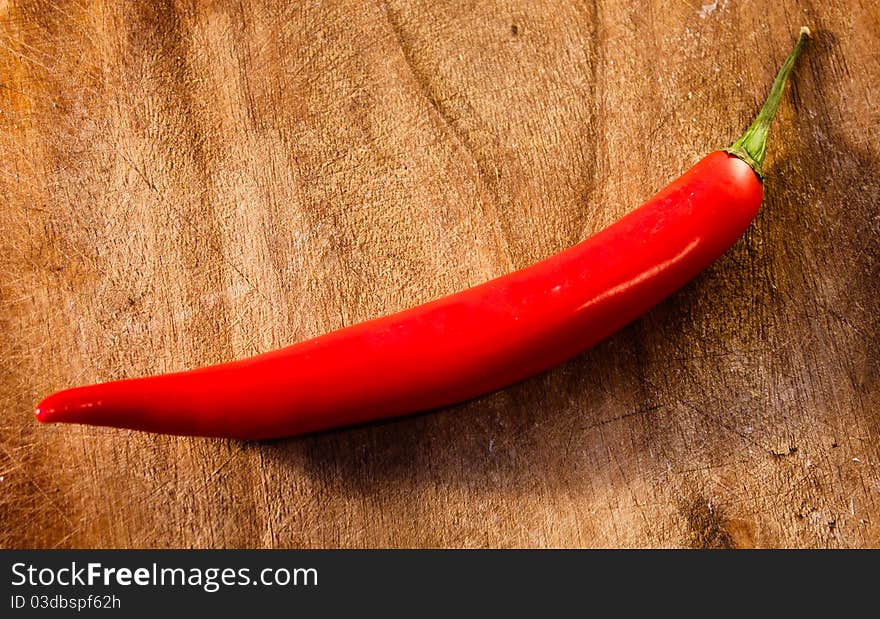 Red Hot Chili Pepper on the old wooden background