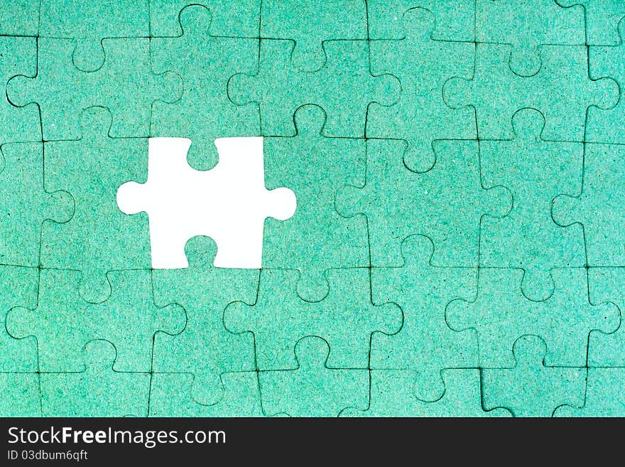 Green puzzle with missing piece