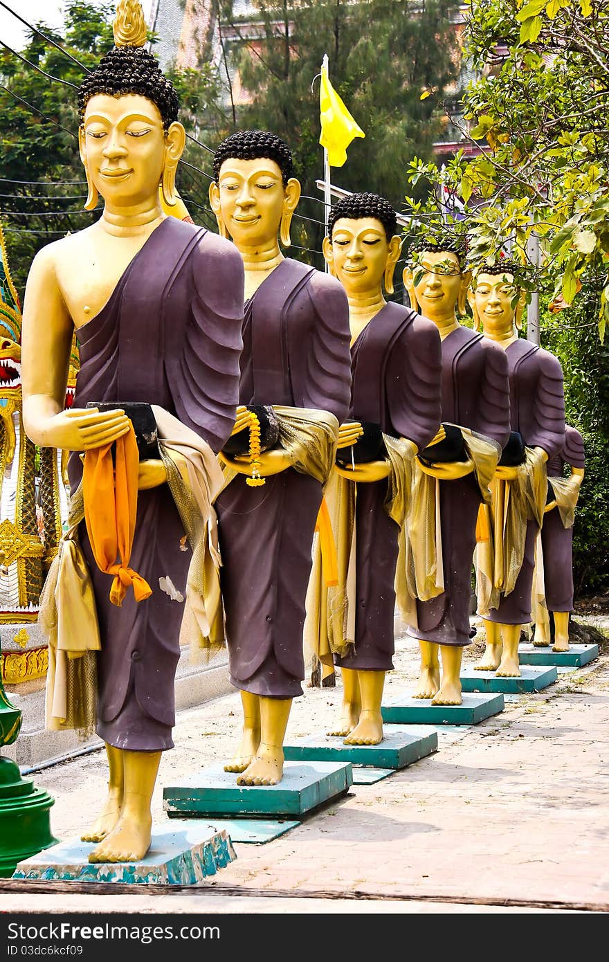 Row of monks receive food