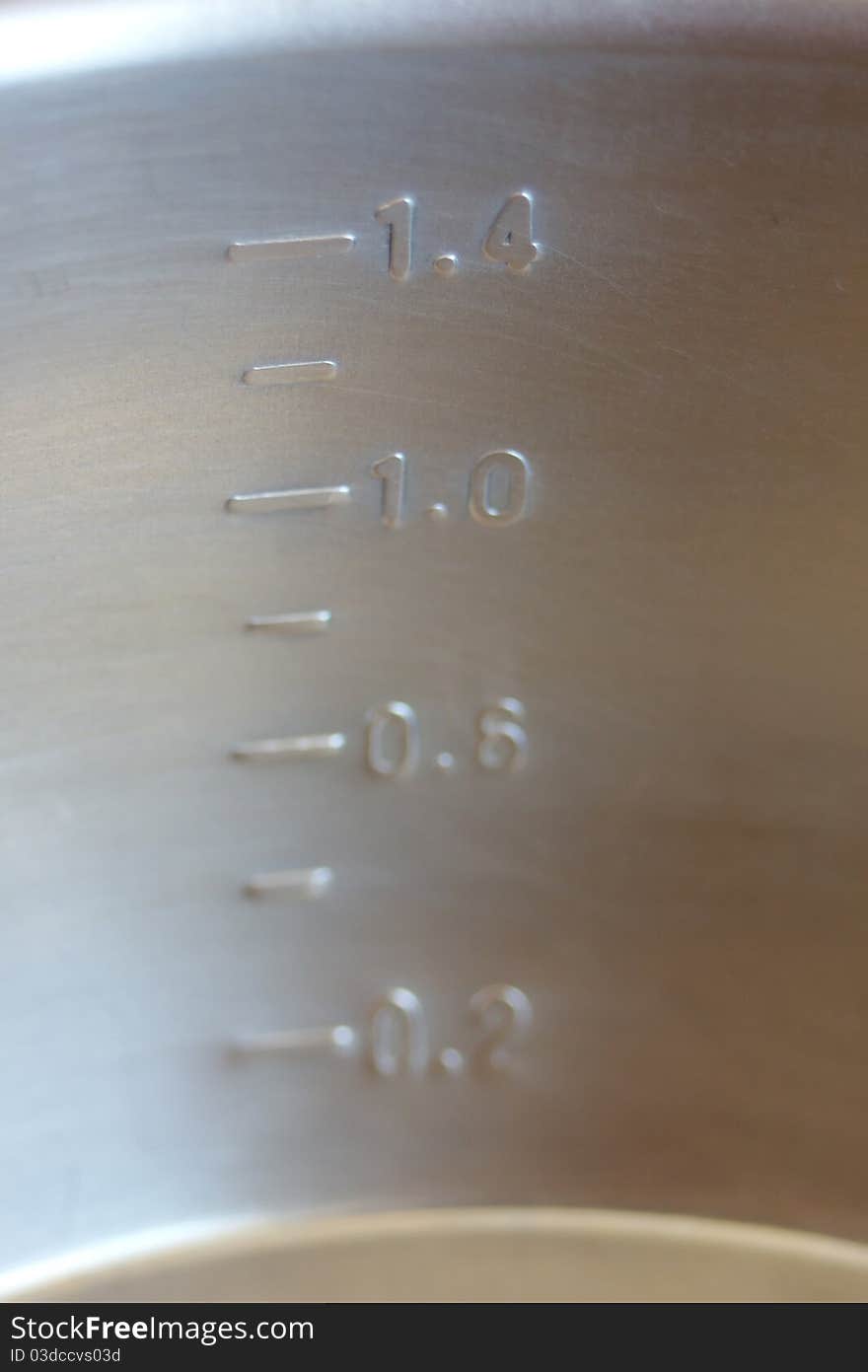 Metal measuring pot - close-up of the scale