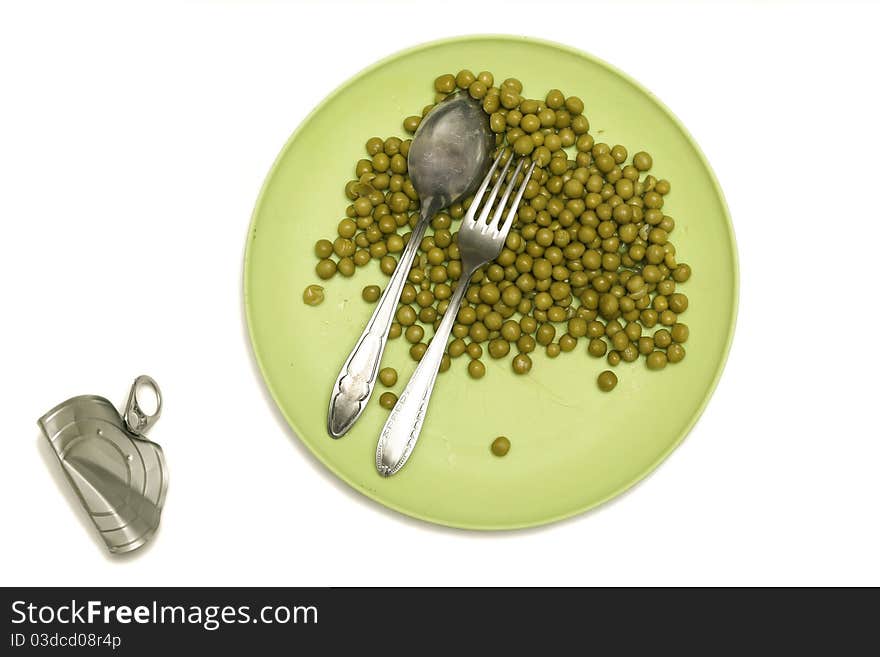 Green peas in a bowl with a fork and spoon