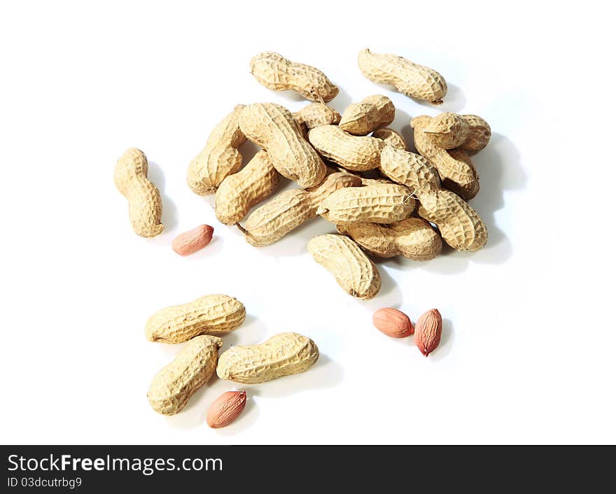 Peanut shells and nut on white background.