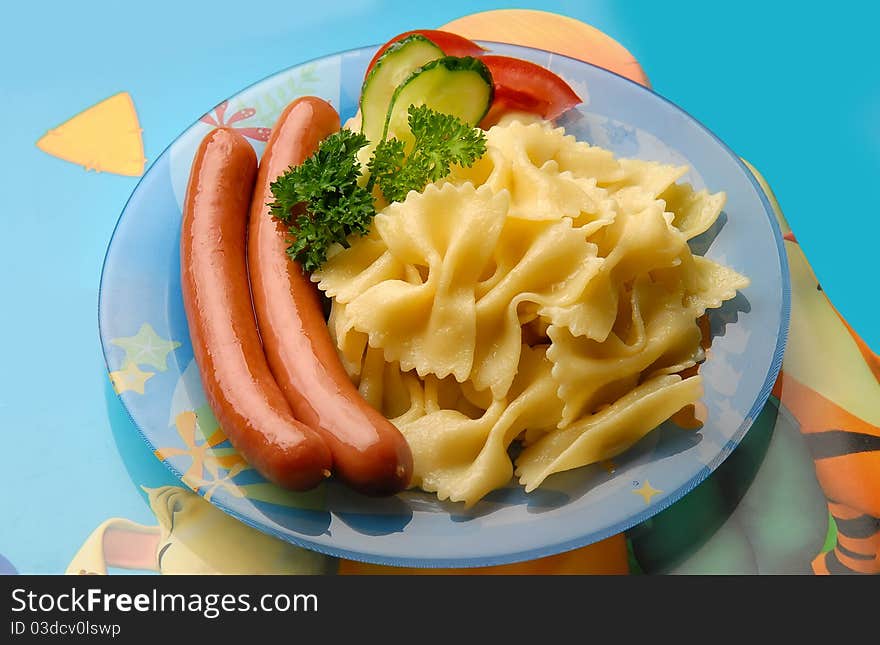 pasta with sausage and vegetables on the plate