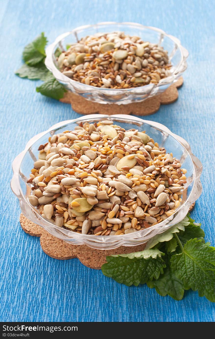 Seeds in glass bowl with fresh herbs. Seeds in glass bowl with fresh herbs