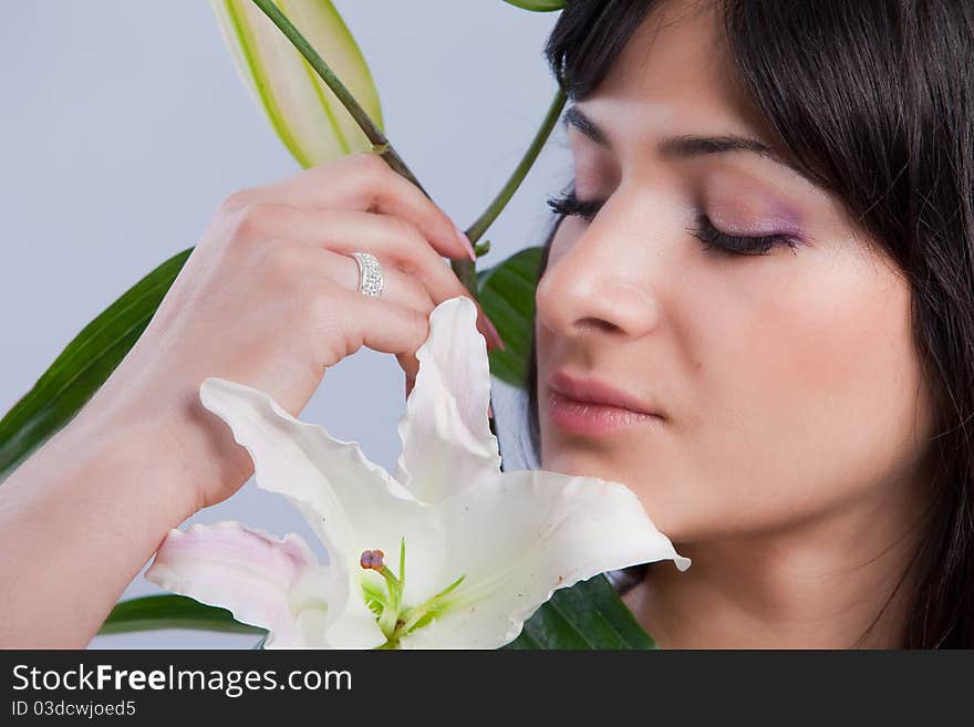 Beautiful young woman with fresh clean skin and white flower. Beautiful young woman with fresh clean skin and white flower