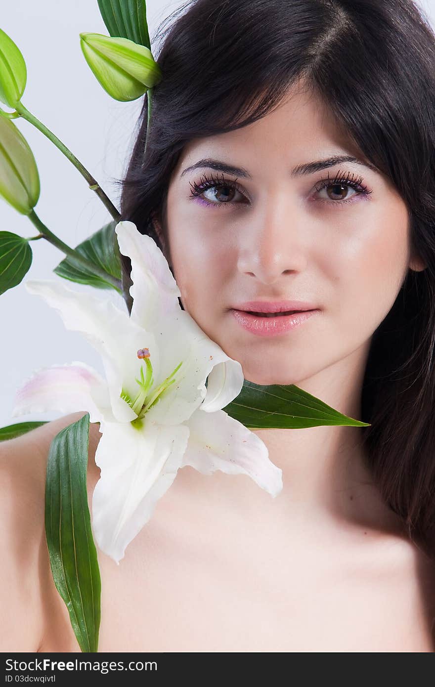 Beautiful young woman with fresh clean skin and white flower. Beautiful young woman with fresh clean skin and white flower