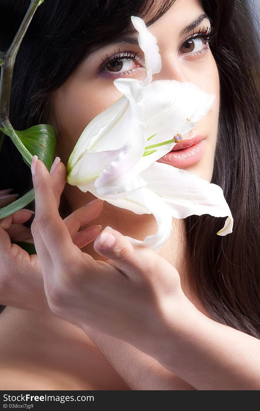 Beautiful young woman with fresh clean skin and white flower. Beautiful young woman with fresh clean skin and white flower