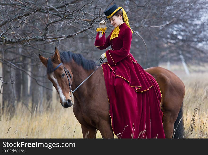 Horsewoman in vintage stylized suit.