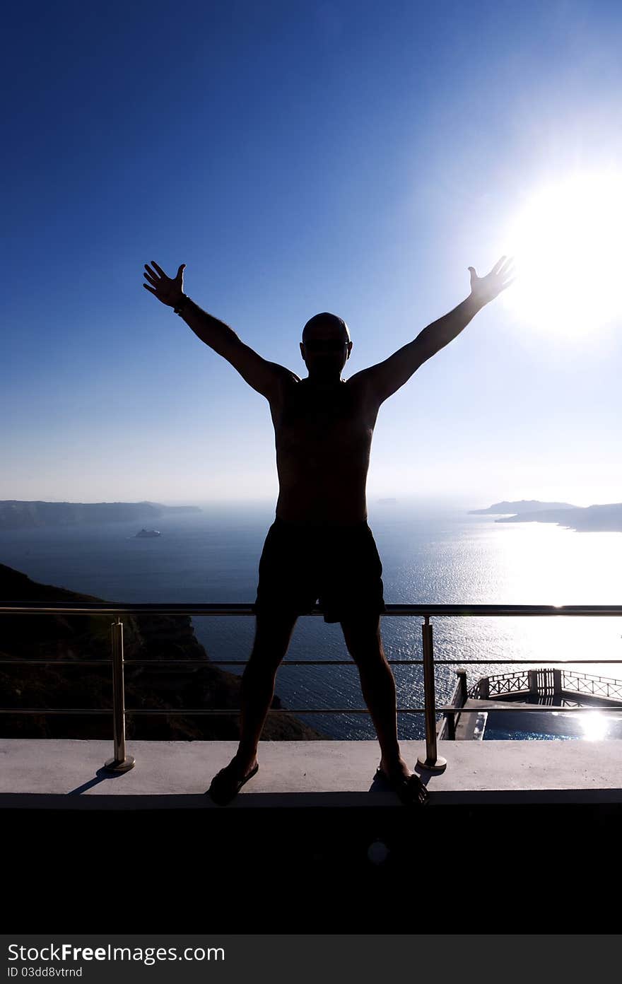 Young man admires the sunset in Santorini, Greece. Young man admires the sunset in Santorini, Greece