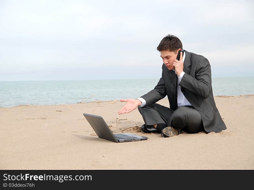 Businessman talking on beach