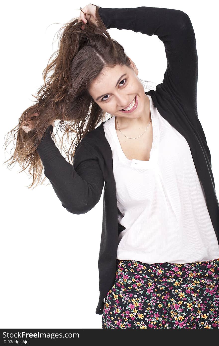 Young and smiling girl having fun and pulling her long hair