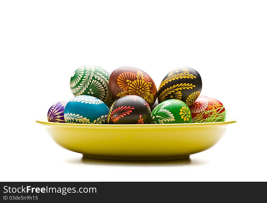 Painted Easter eggs on yellow plate. Painted Easter eggs on yellow plate