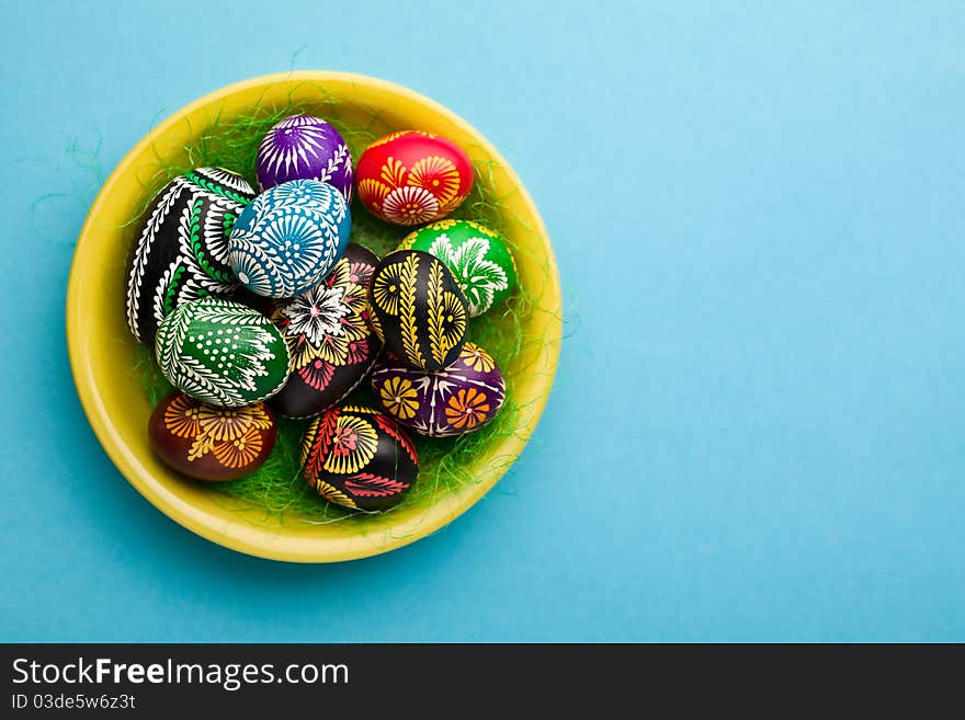 Painted Easter eggs on yellow plate. Painted Easter eggs on yellow plate