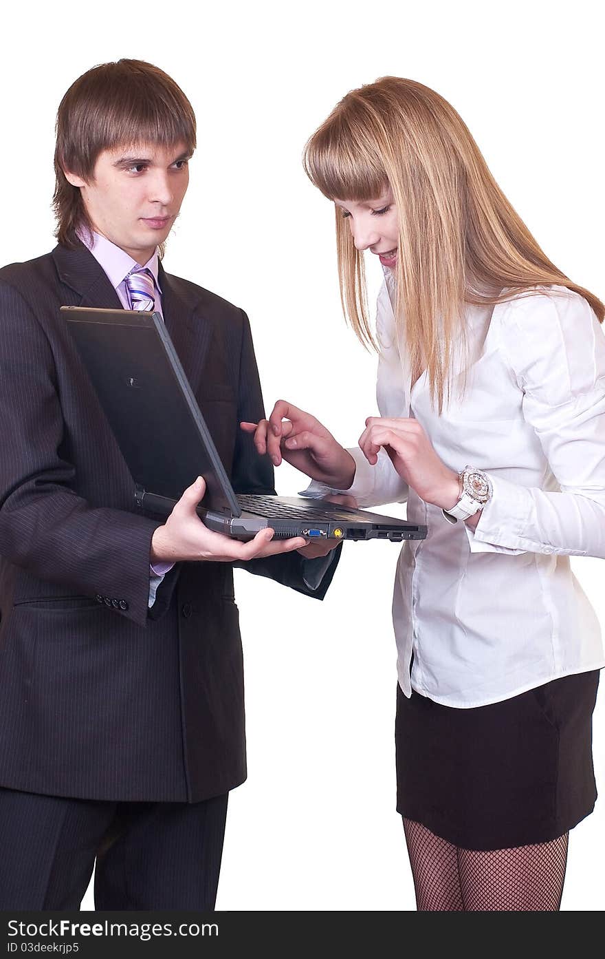 Man and woman in business suits working on laptop computer. Shot in studio over white. Man and woman in business suits working on laptop computer. Shot in studio over white.