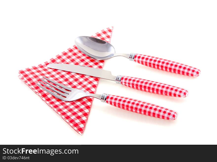 Modern red white checkered cutlery with a napkin isolated on white background