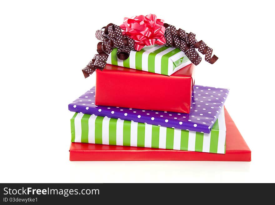 A stack of cheerful presents with bows isolated over white