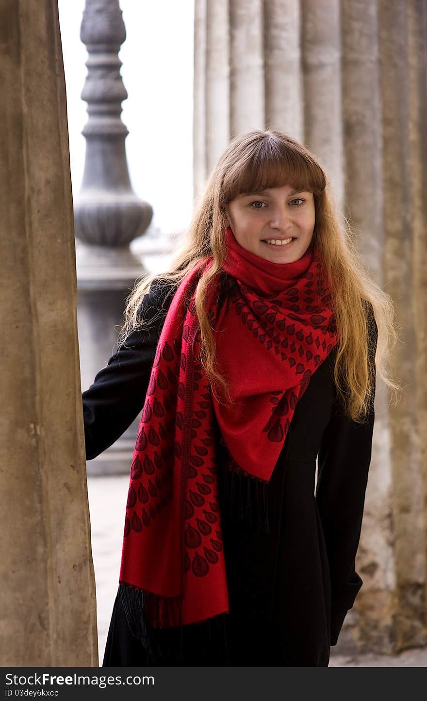 Beautiful young blond girl in the red scarf and black coat. Beautiful young blond girl in the red scarf and black coat