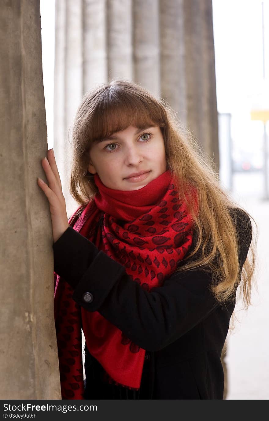 Beautiful young blond girl in the red scarf and black coat. Beautiful young blond girl in the red scarf and black coat