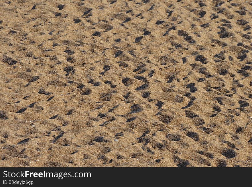 Foot prints in sand on sunset warm light. Foot prints in sand on sunset warm light