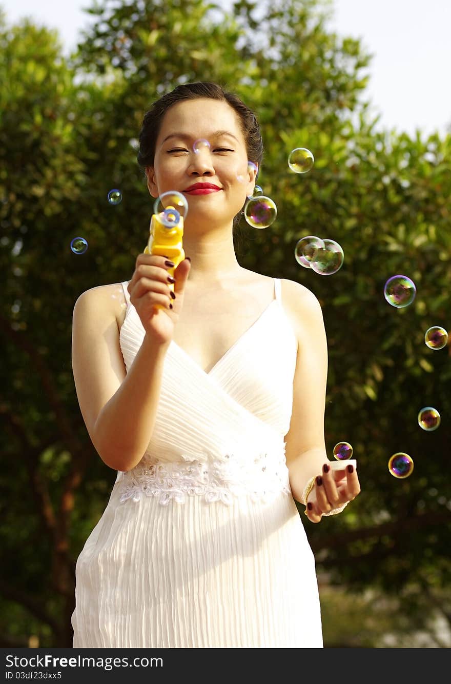 Portrait of young woman blowing soap bubbles. Portrait of young woman blowing soap bubbles