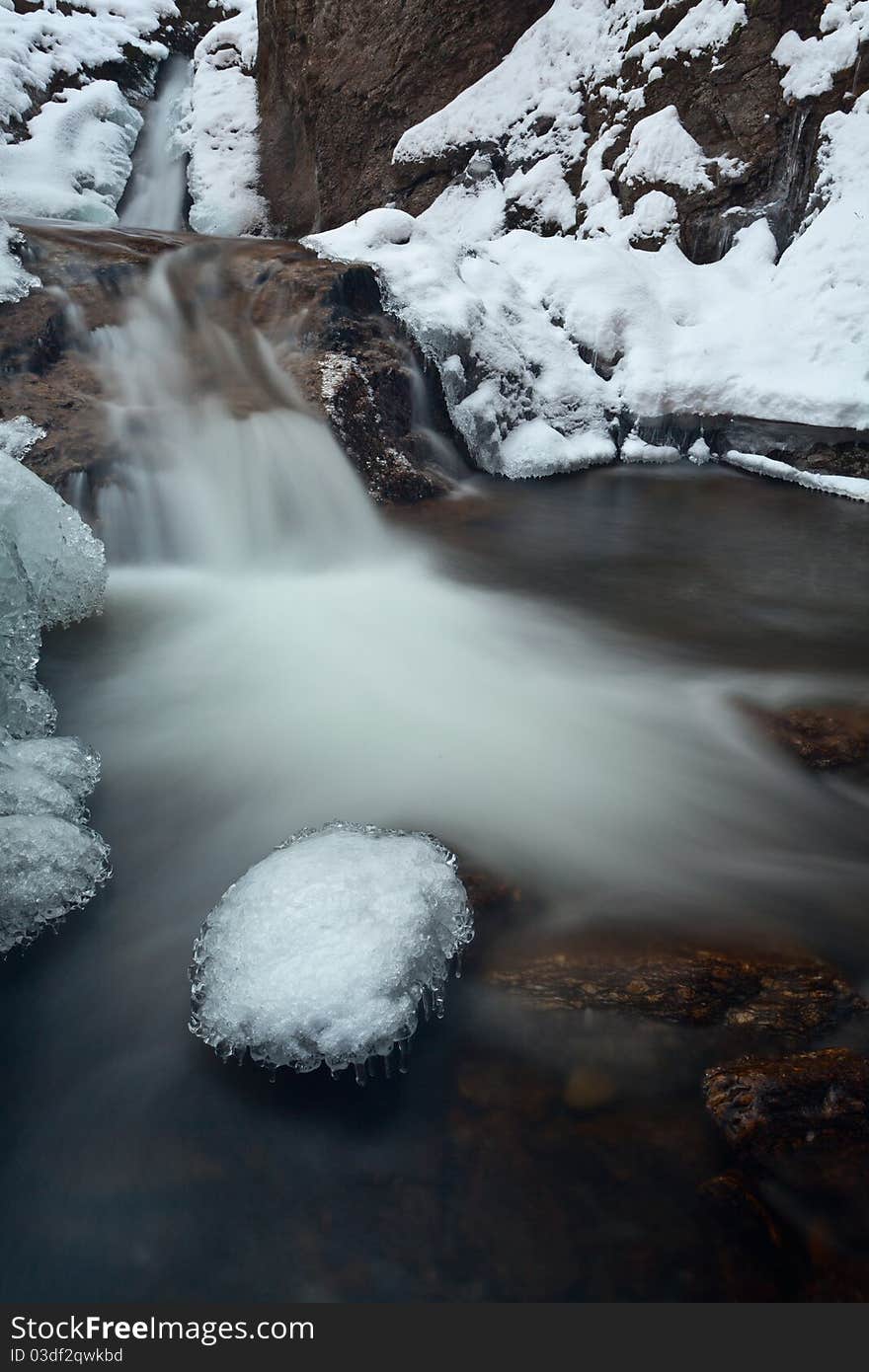 Mountain waterfall with some some at the end of winter. Mountain waterfall with some some at the end of winter