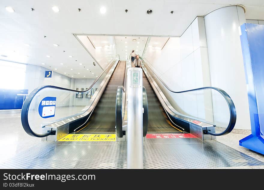 People at the airport escalator