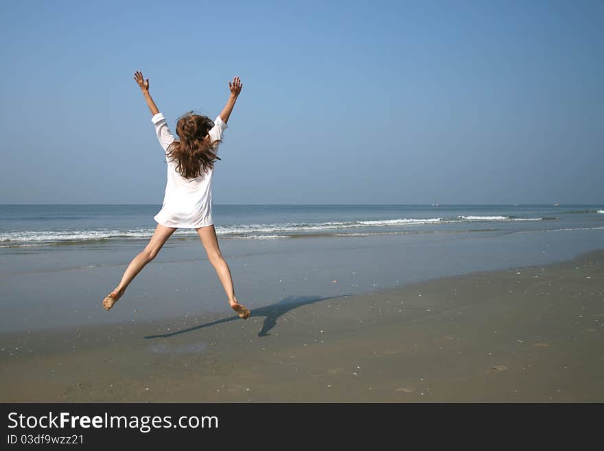 Woman on the beach near sea and blue sky