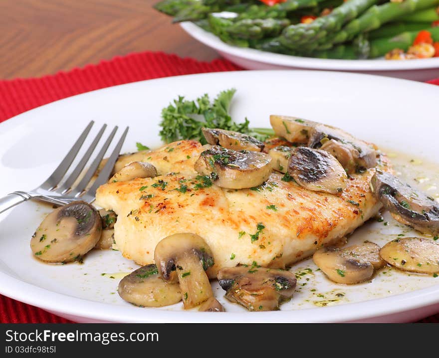 Fried chicken breast covered with a mushroom sauce. Fried chicken breast covered with a mushroom sauce