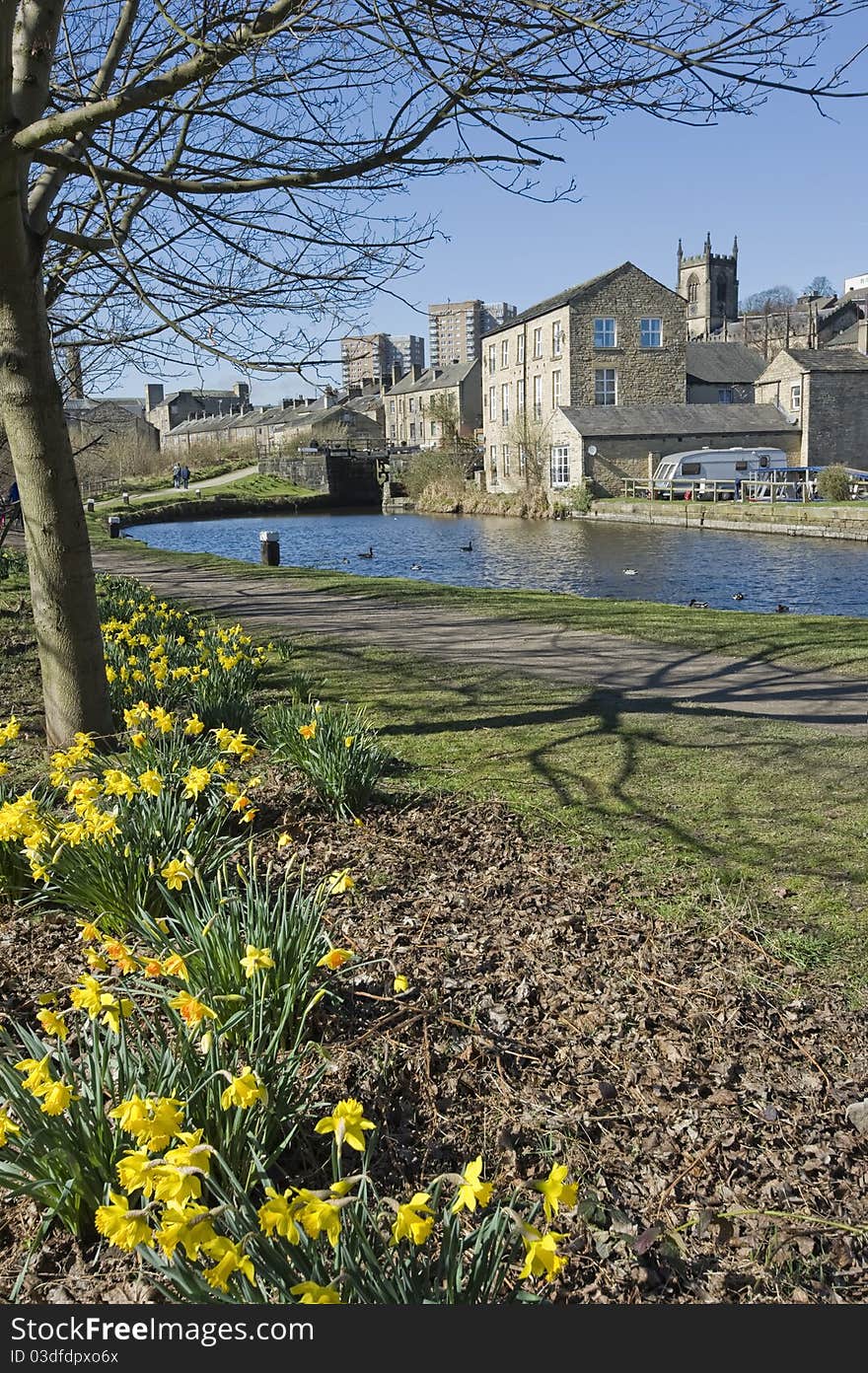 Canal lock on clear spring day with daffodils in foreground. Canal lock on clear spring day with daffodils in foreground