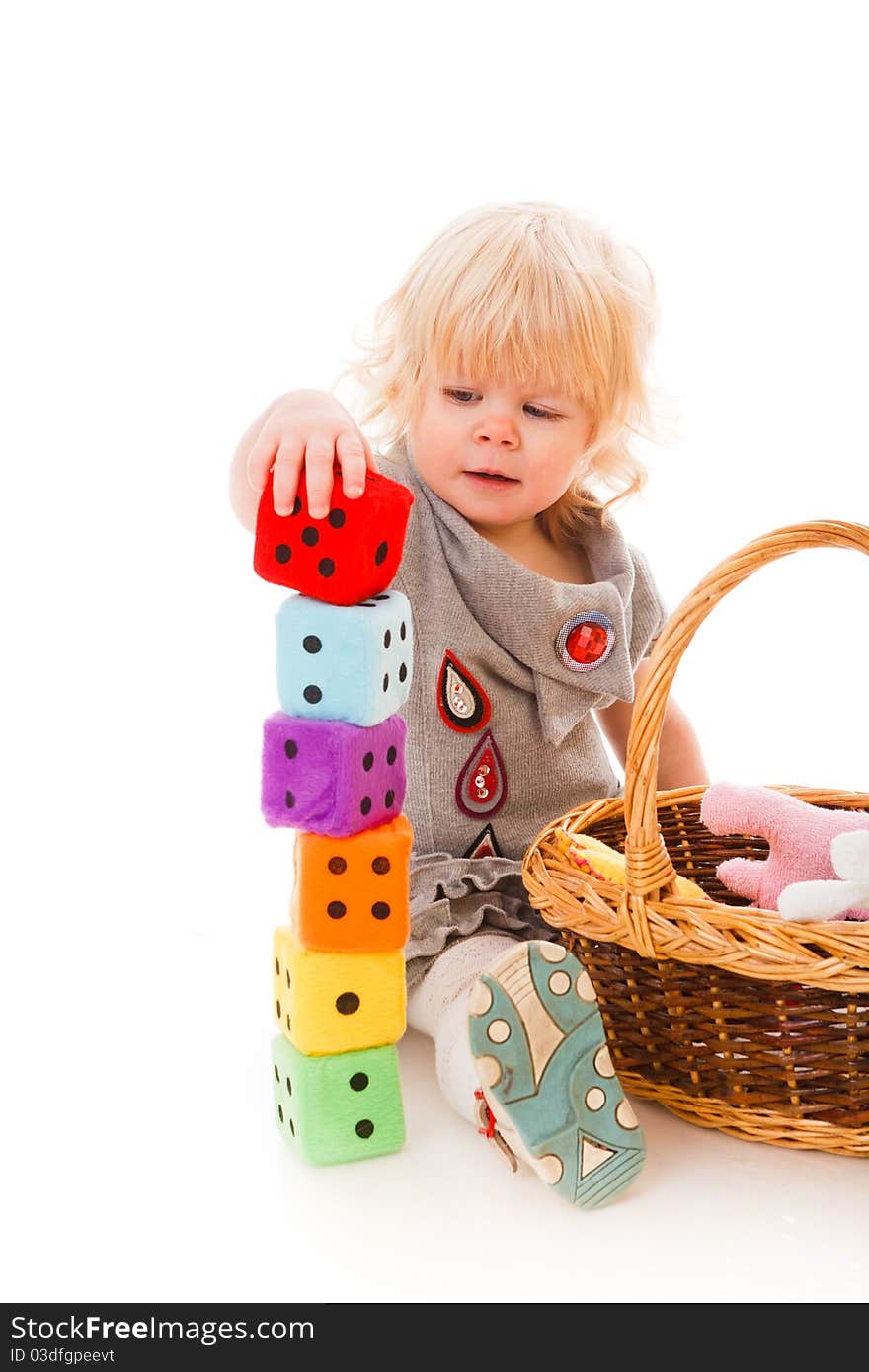 Little blonde haired girl playing with toys. Little blonde haired girl playing with toys