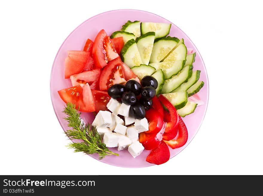 Plate of fresh cut vegetables across white