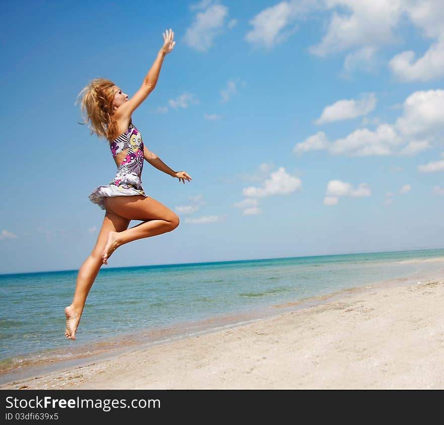 Attractive woman jumping on beach