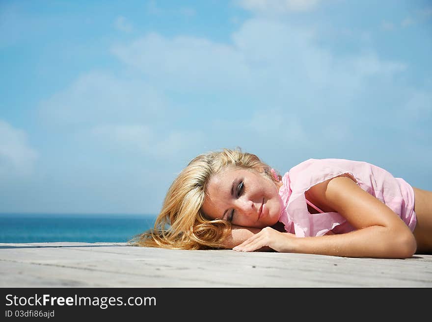 Attractive woman relaxing on sea background