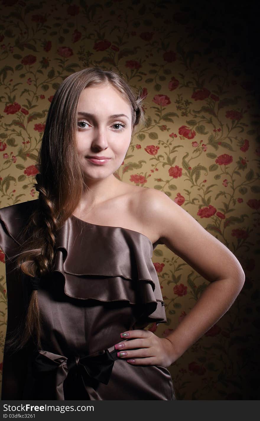 Portrait of the beauty young blond girl near the wall with roses