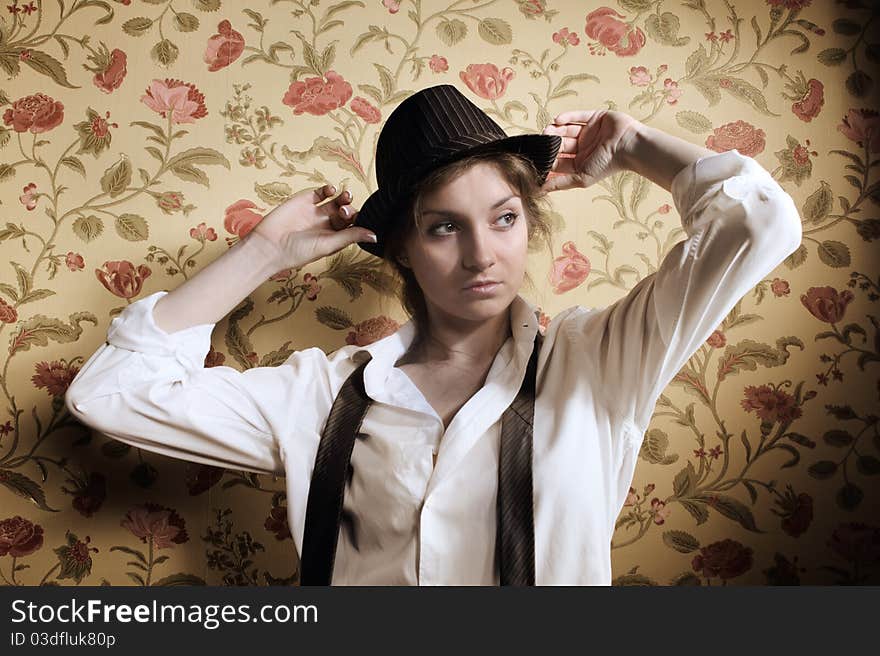 Portrait of the beautiful stylish brunette girl in hat