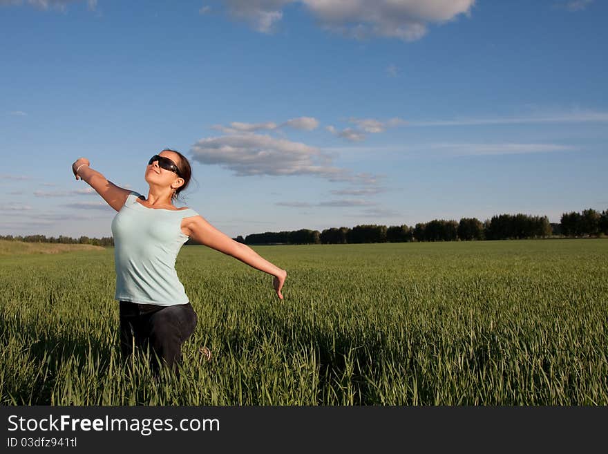 Young woman relaxing at green grass field