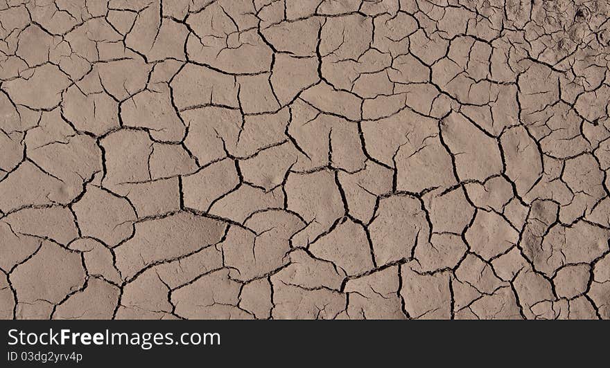 Brown clacked and dry desert soil closeup. Brown clacked and dry desert soil closeup