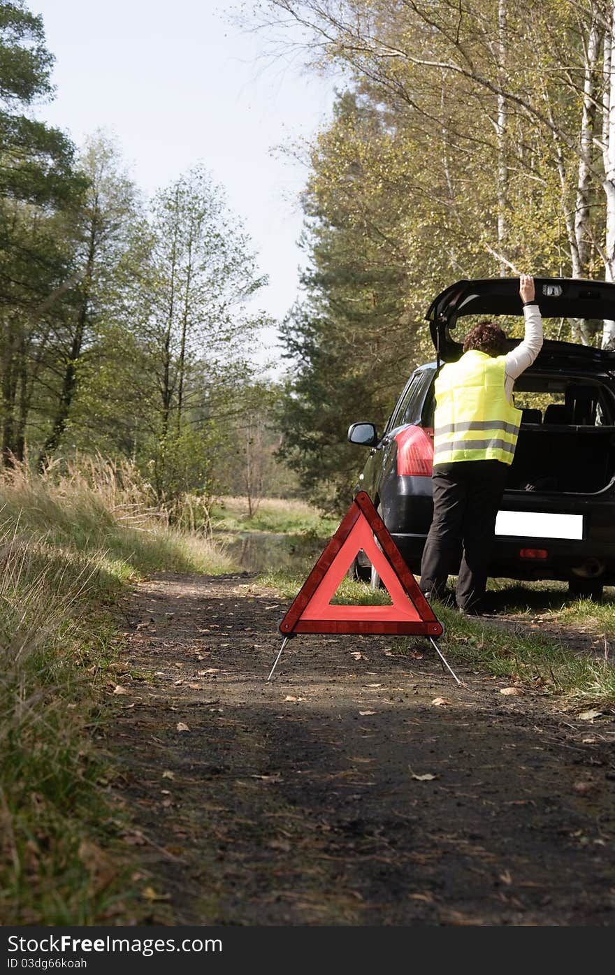 Car breakdown and red triangle.