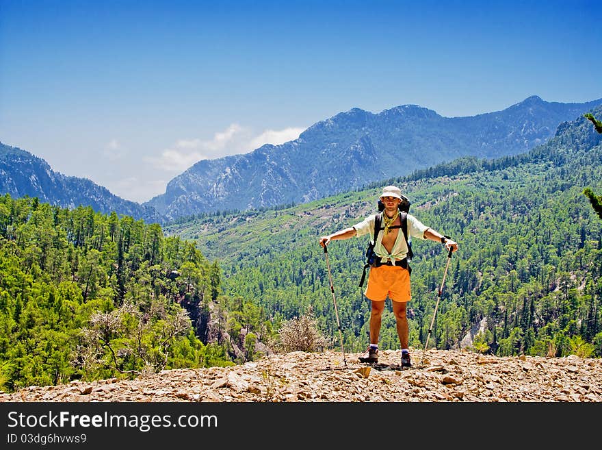 Portrait of hiker standing against the mountains