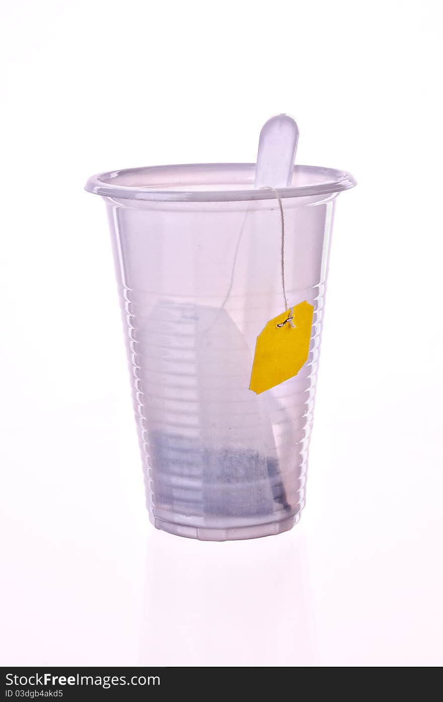 Tea in a plastic glass on a light grey background