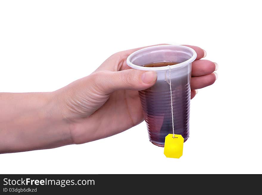 Tea in a plastic glass on a light grey background