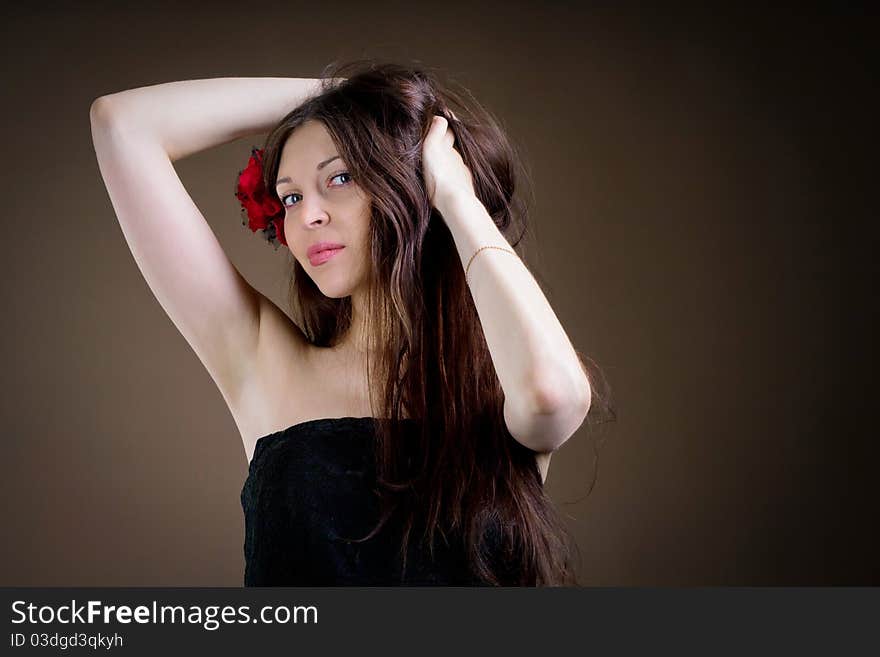 Portrait of attractive woman with flower in hair