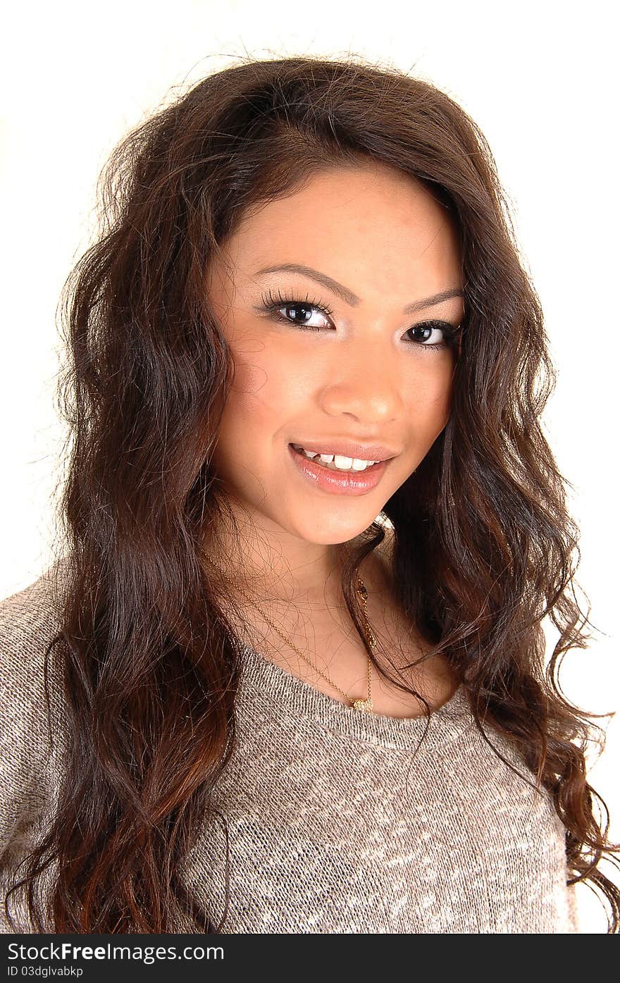 A closeup portrait of a young beautiful Asian woman with long curly brunette hair, for white background. A closeup portrait of a young beautiful Asian woman with long curly brunette hair, for white background.