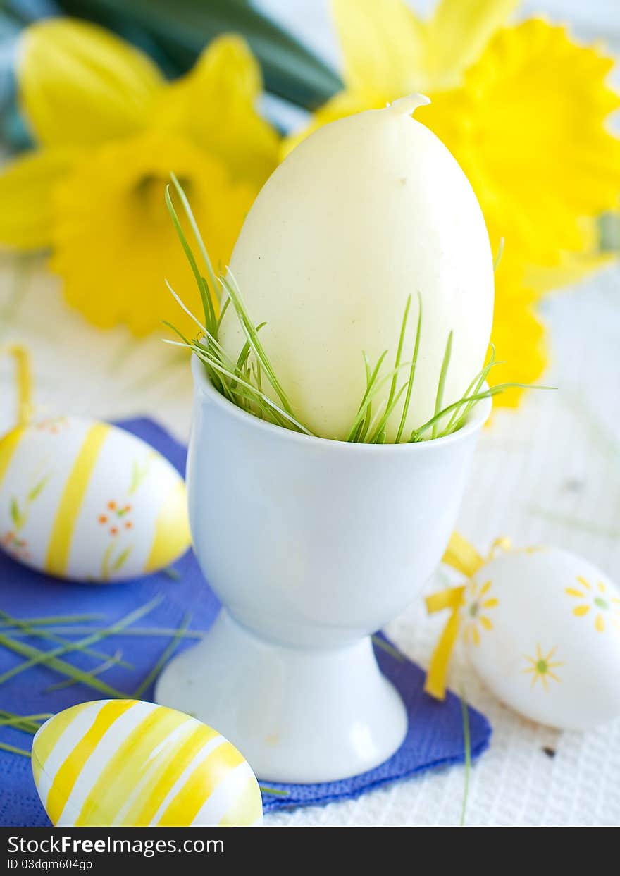 Easter Eggs in eggcup with flower on background