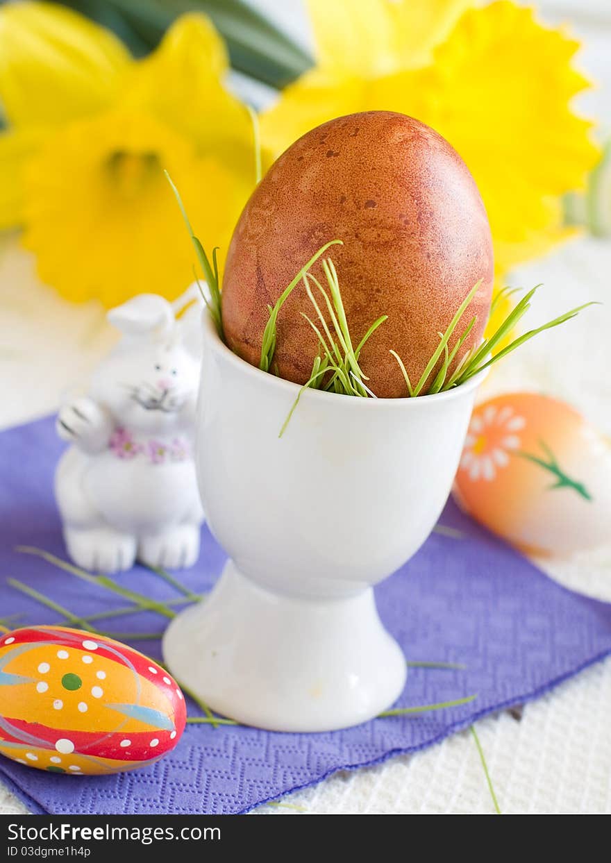 Easter Eggs in eggcup with flower on background