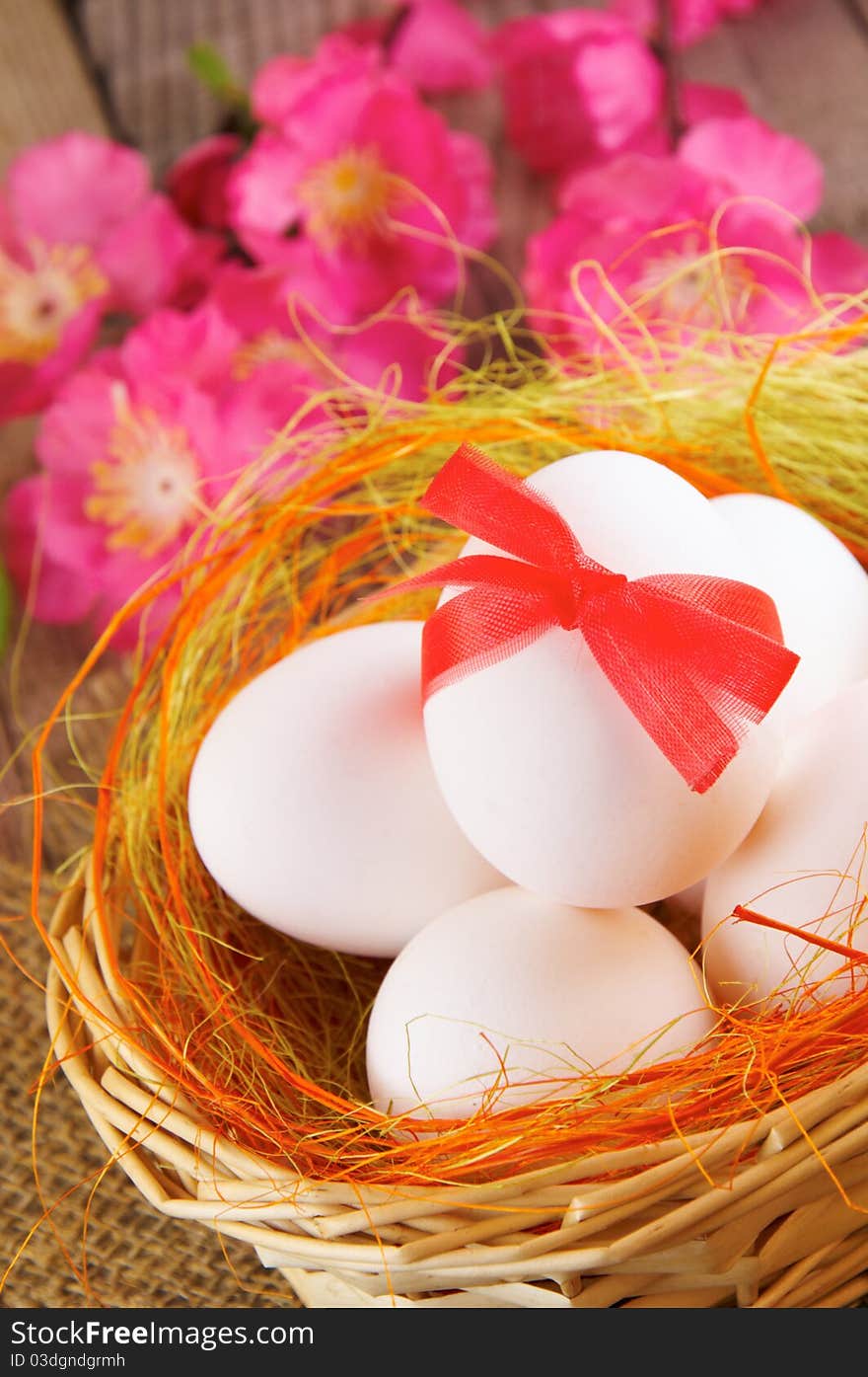 Easter still-life. Eggs in a basket and flowers