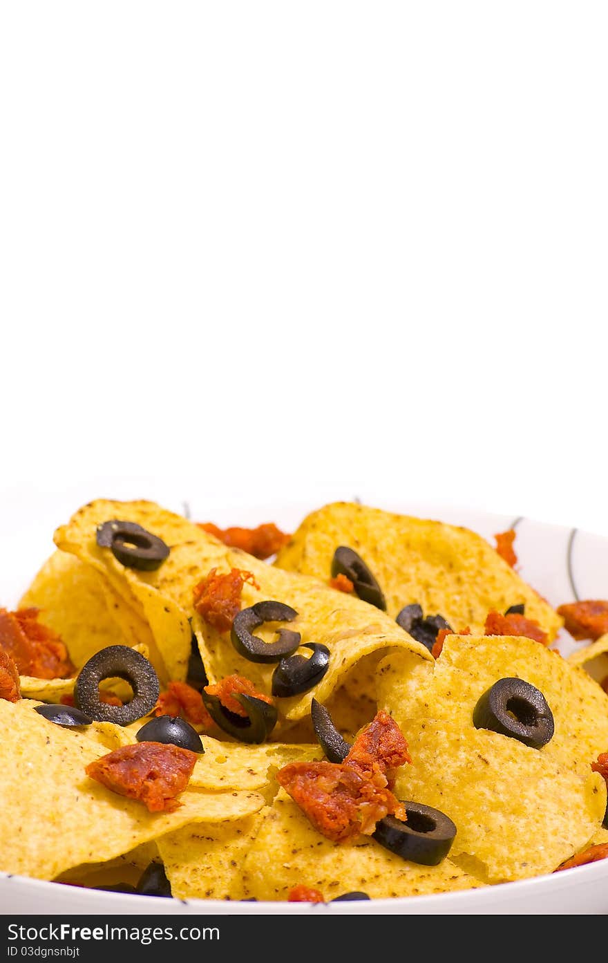 Nacho chips with olives and chorizo